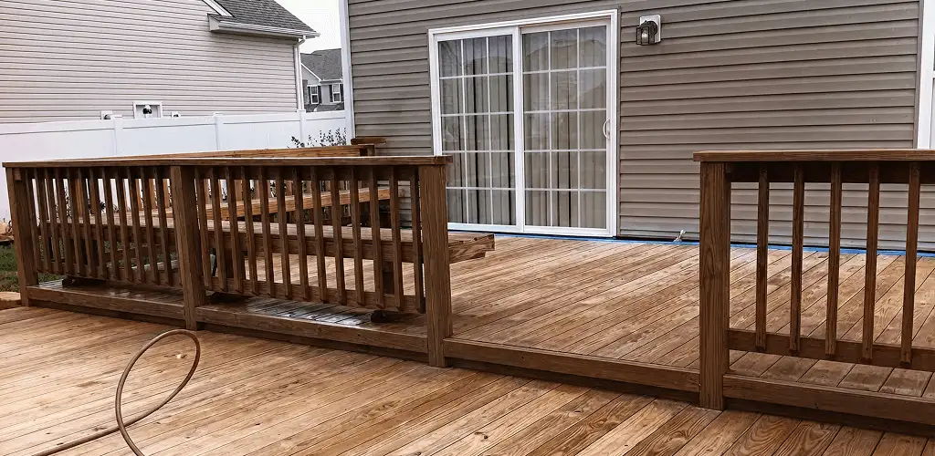Deck sealing service protecting a backyard wood deck and railings in Birmingham, AL