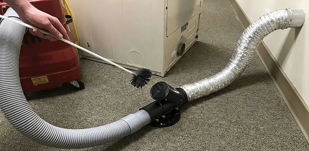 Dryer vent cleaning service removing lint from a dryer duct connection in Birmingham, AL