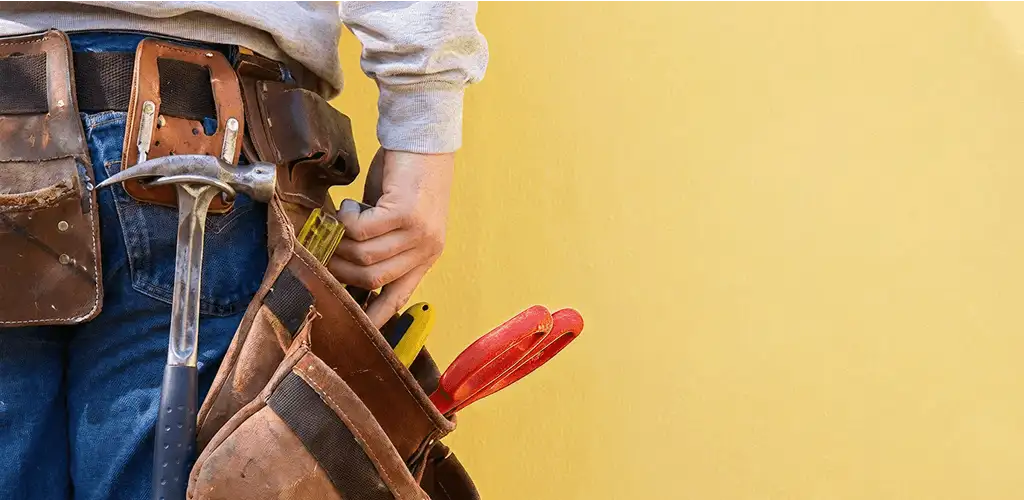 Handyman with tool belt ready for home repairs and maintenance in Birmingham, AL