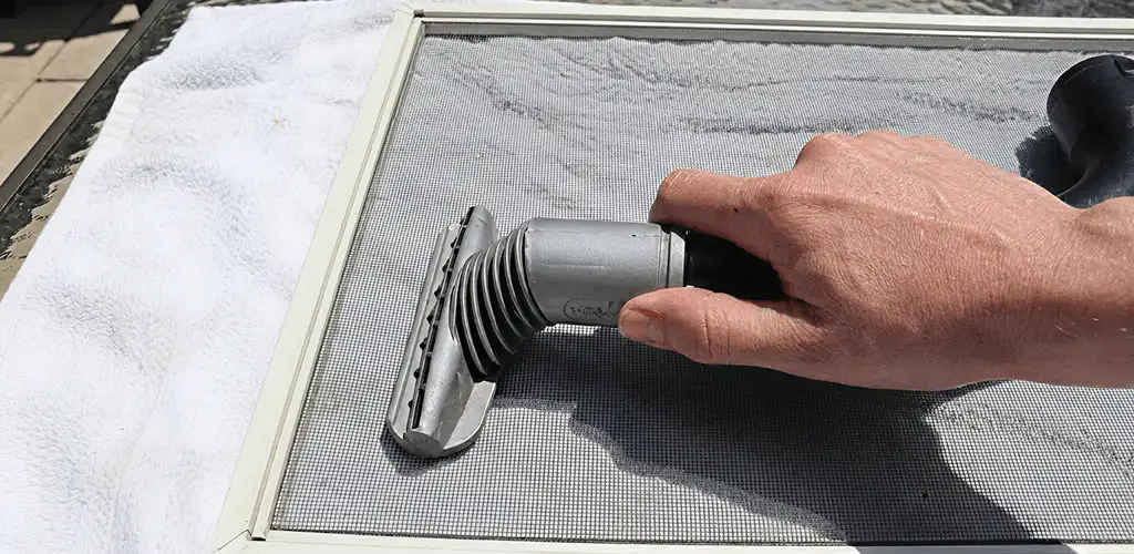 Window screen repair cleaning and fixing a damaged screen mesh in Birmingham, AL